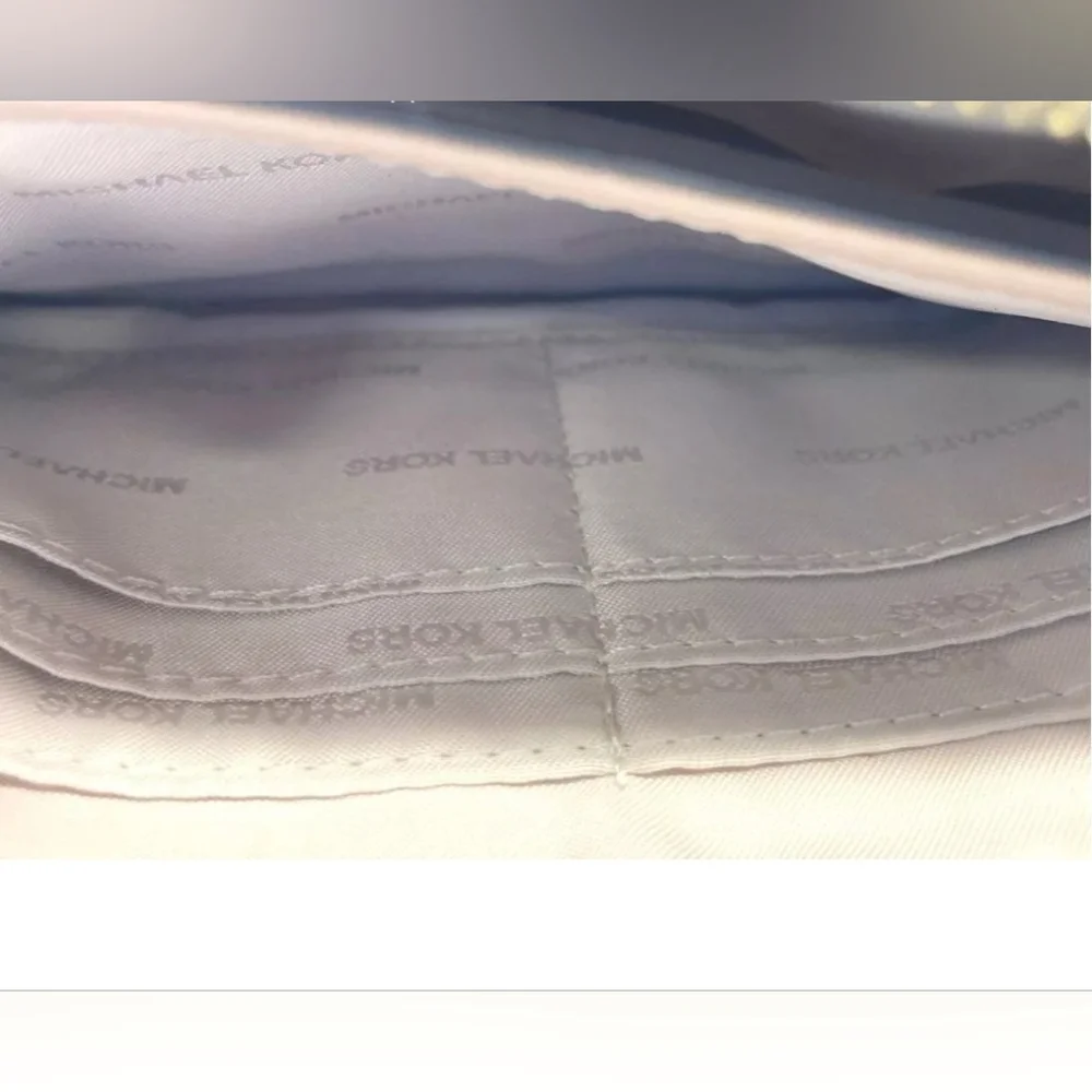 Michael Kors tan wristlet.